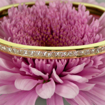 gold bracelet on pink flower
