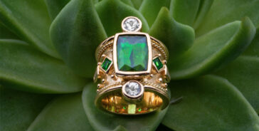 gold ring with green stones