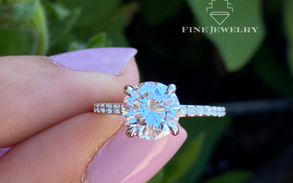 dainty accented band round diamond engagement ring, delicate accent band round diamond ring, round brilliant engagement ring with dainty band, thin band round diamond engagement ring, petite band round diamond ring, round diamond engagement ring with accent diamonds, dainty pavé band round diamond ring, minimal accent band round diamond ring, slender band round diamond engagement ring, delicate round diamond ring with side accents